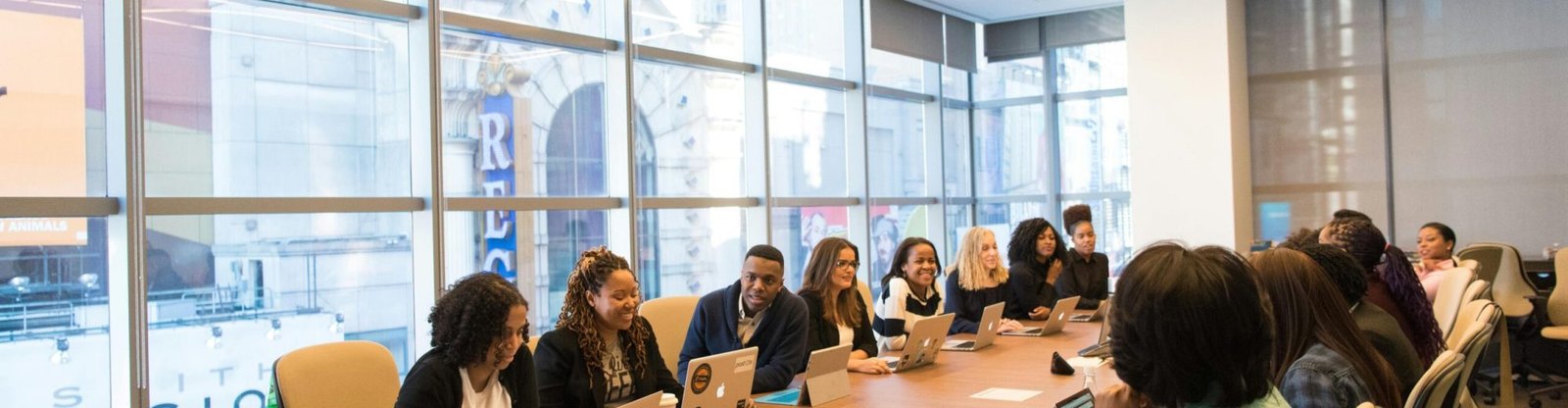 A diverse team of business professionals collaborating in a modern meeting room.