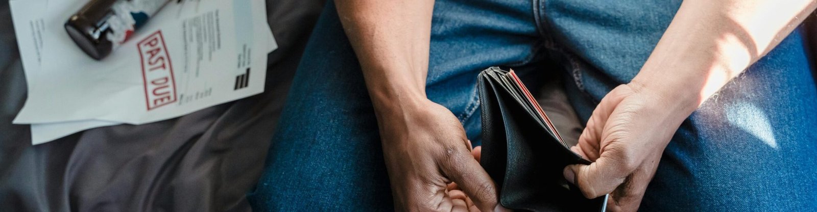 Depicts financial stress with overdue bills and empty wallet.